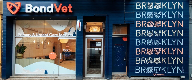 A veterinary clinic storefront with the words "primary & urgent care for pets" and the name "bondvet" displayed on the window.