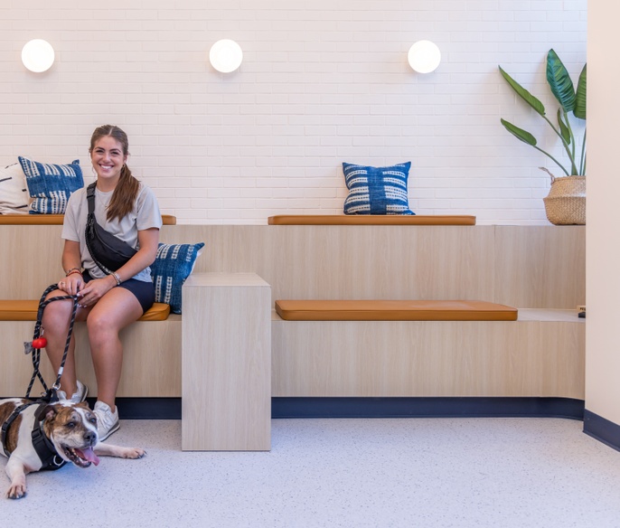 Pet parent and dog in lobby in Bond Vet - Seaport